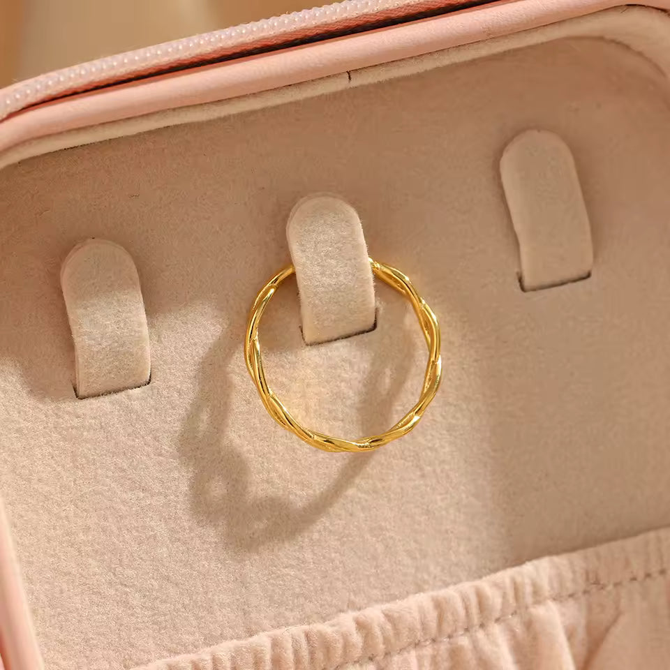 Gold ring in a jewelry box with pink interior