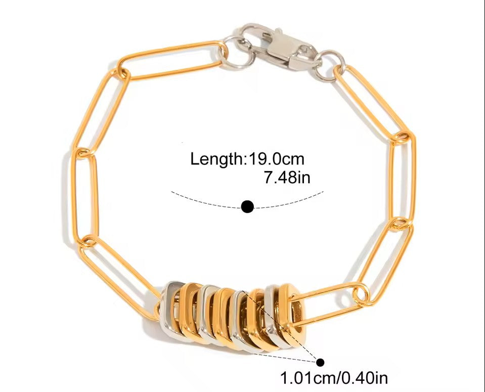 Gold and silver bracelet with measurement details on a white background
