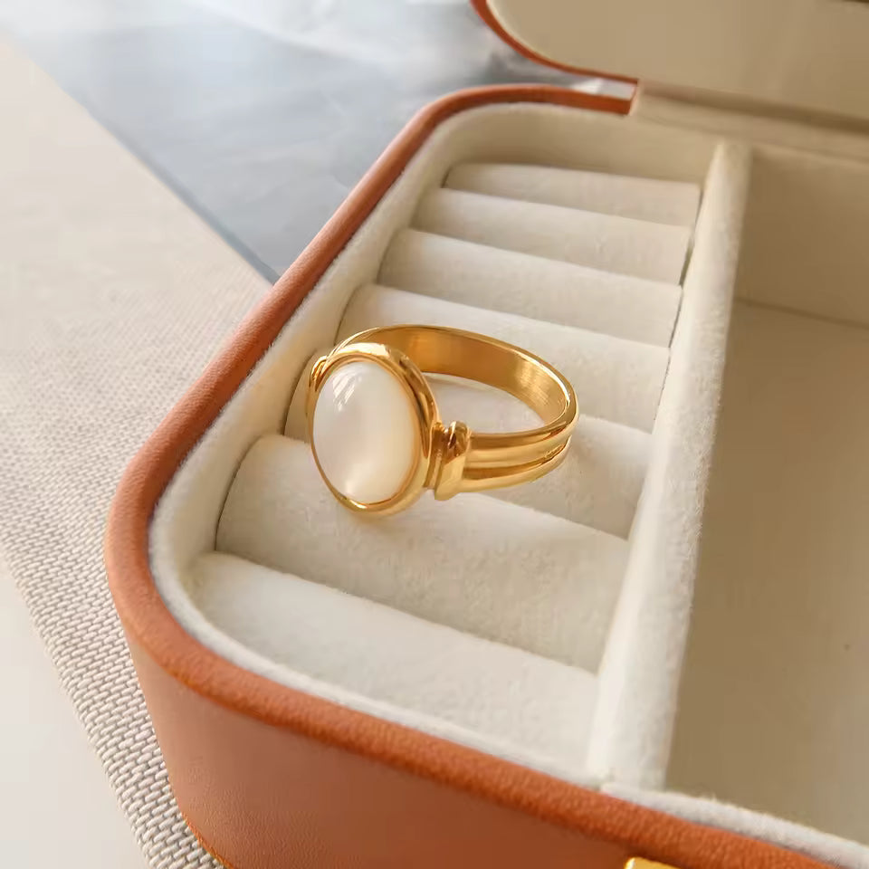 Gold ring with a large stone in an open jewelry box