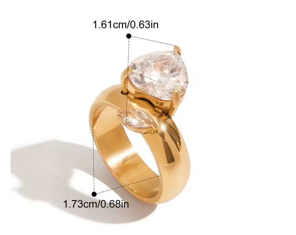 Gold ring with a large diamond and measurements on a white background