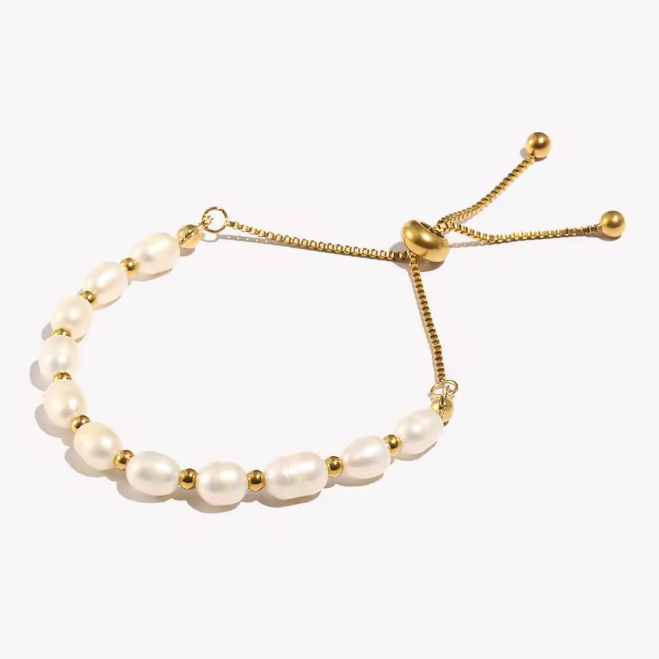 Gold and Pearl adjustable bracelet on a clear stand.