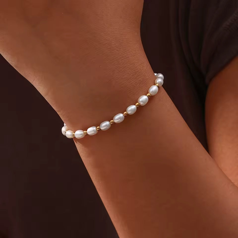 Gold and Pearl Adjustable Bracelet worn by a person