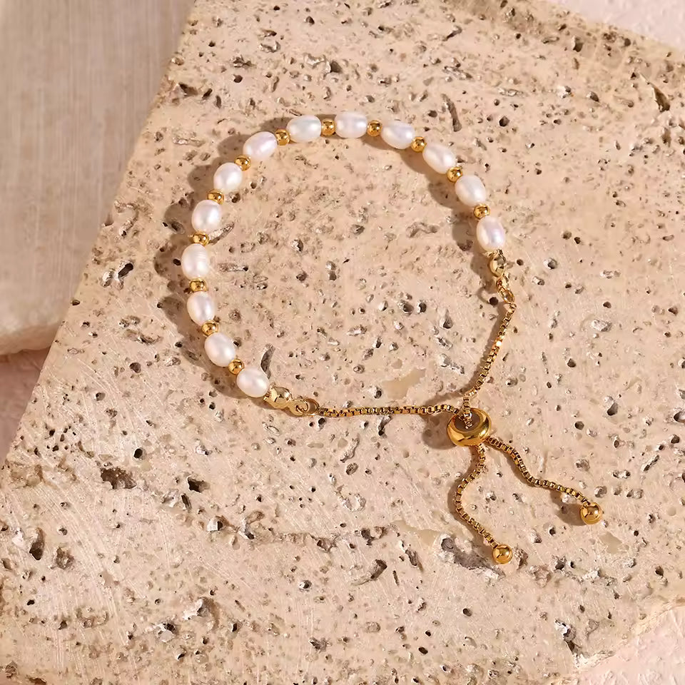 Gold and Pearl Adjustable Bracelet on a stone