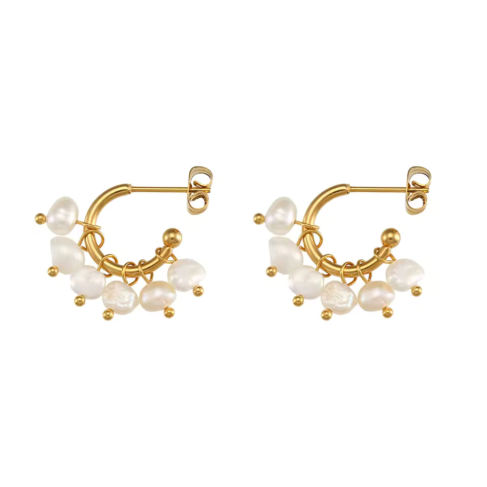 Gold hoop earrings with pearl beads on a white background