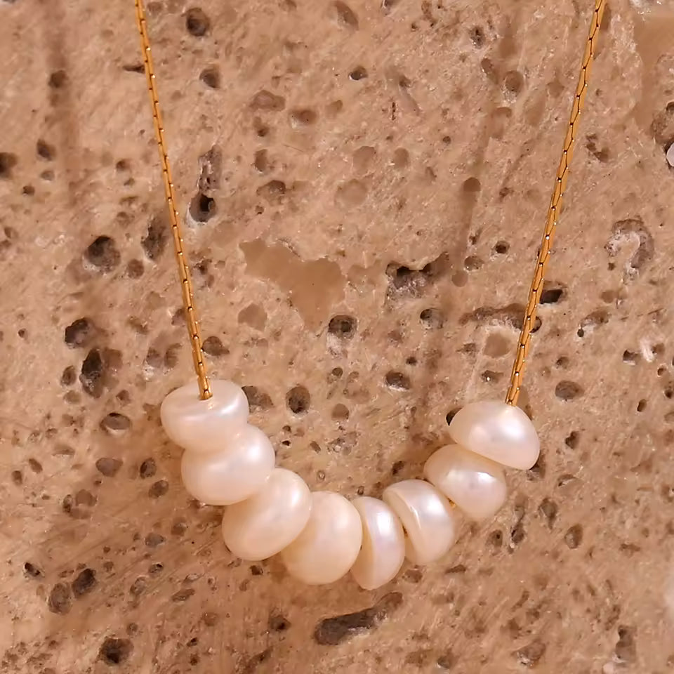 Pearl necklace on a textured beige background