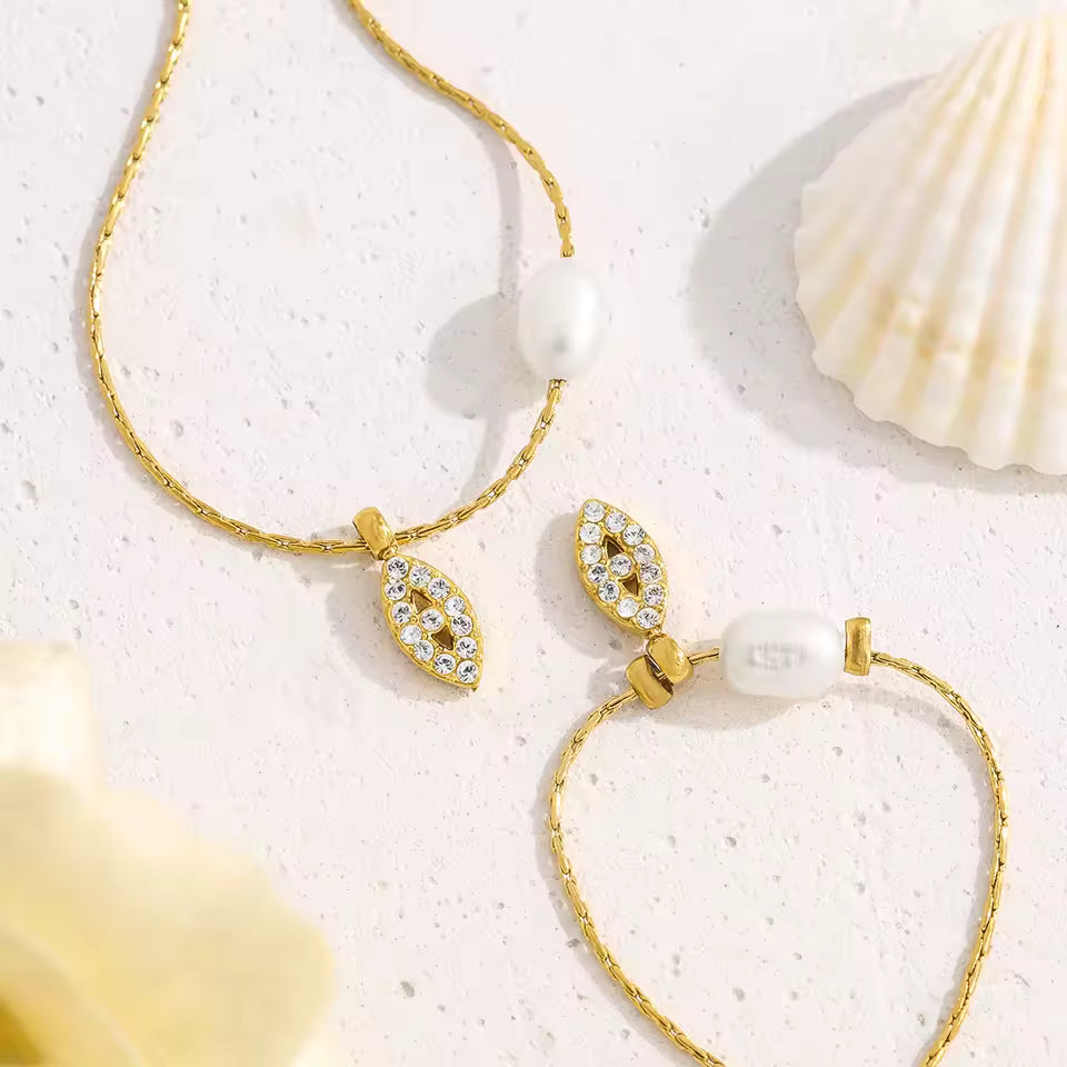 Gold necklace and bracelet with shell background
