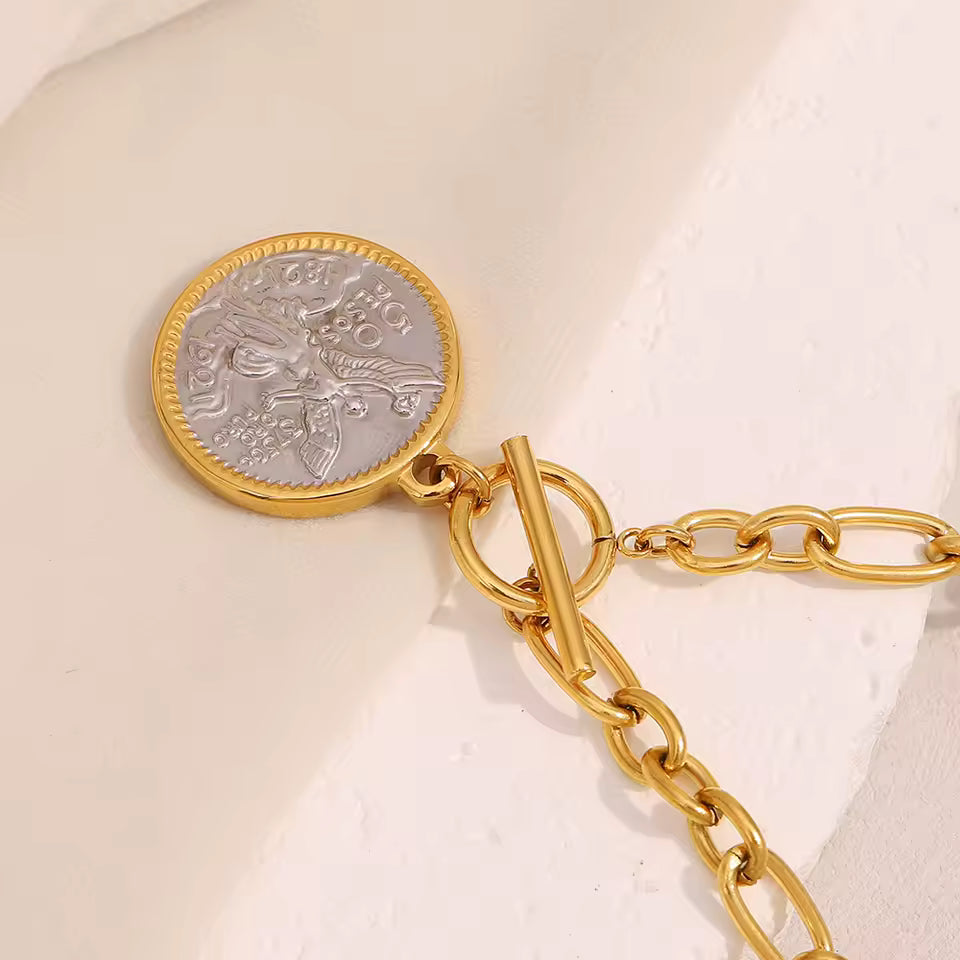Gold Coin Pendant Necklace on counter