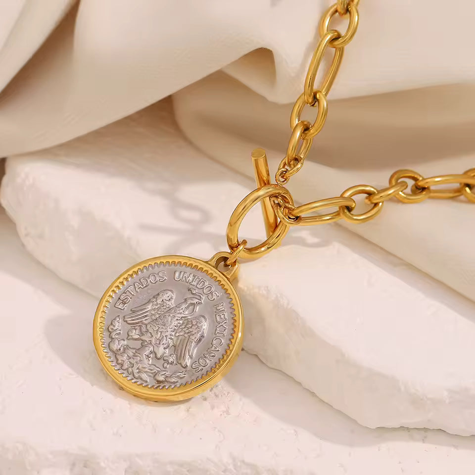 Gold Coin Pendant Necklace on stone