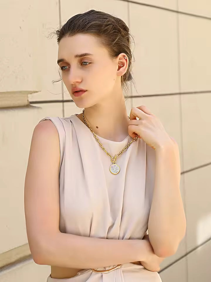 Model wearing gold coin pendant necklace