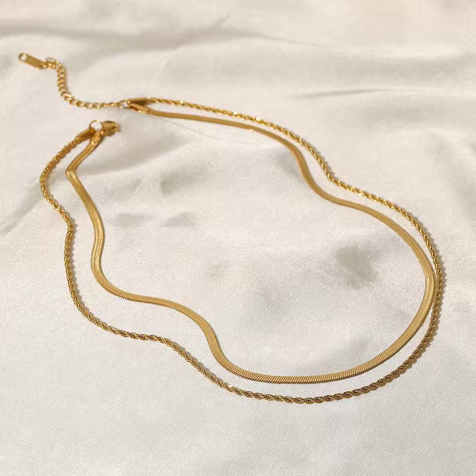 Gold necklace on a white fabric background