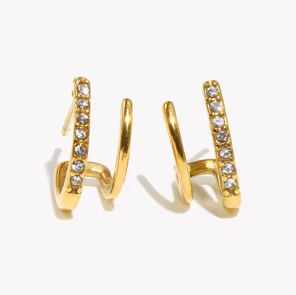 Gold hoop earrings with embedded diamonds on a white background