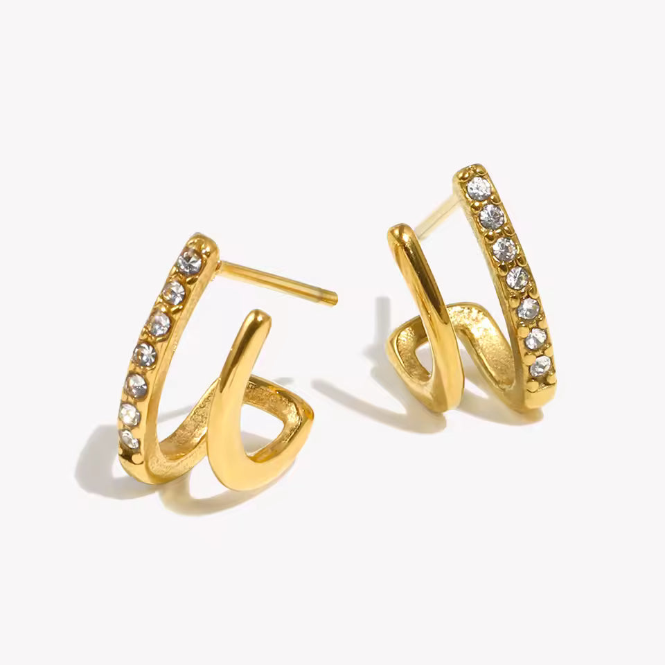 Gold hoop earrings with embedded stones on a white background