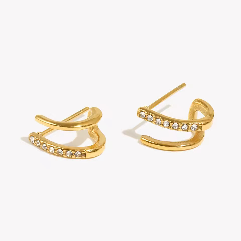 Gold earrings with small diamonds on a white background