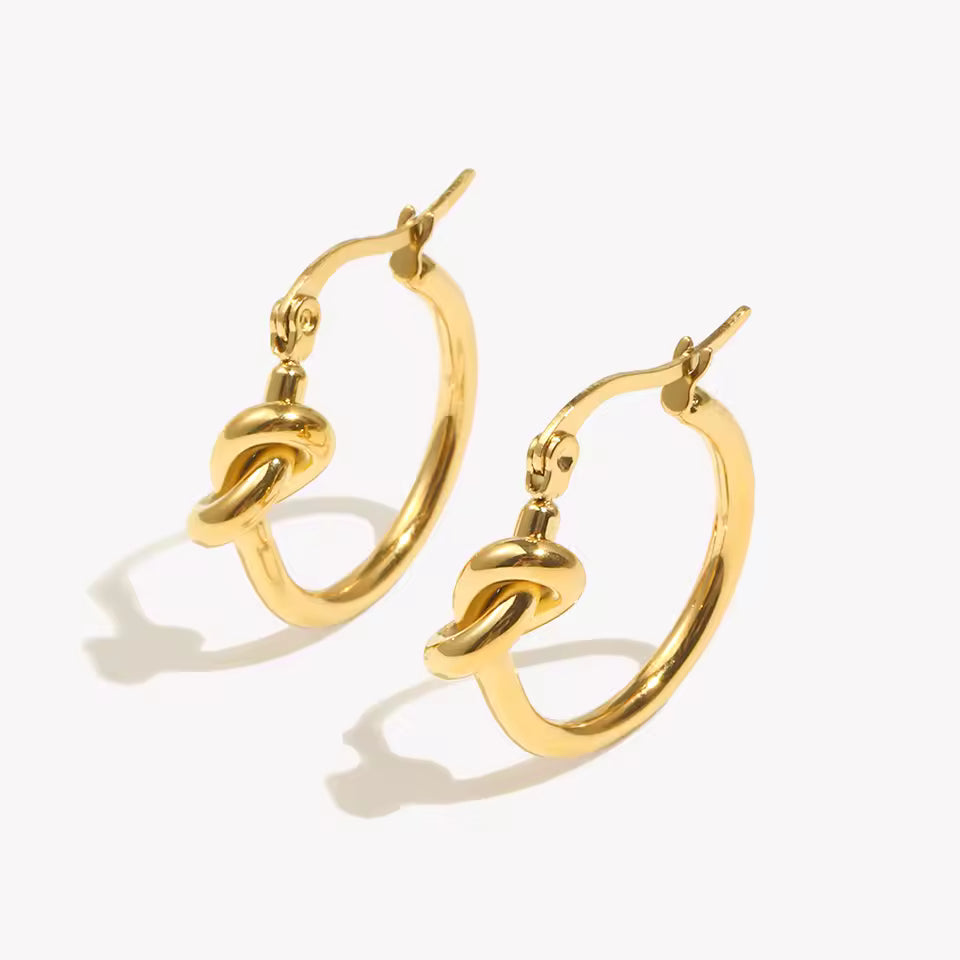 Pair of gold hoop earrings on a white background