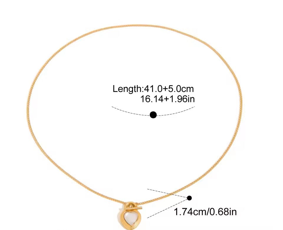 Gold necklace with a heart pendant and measurement details on a white background