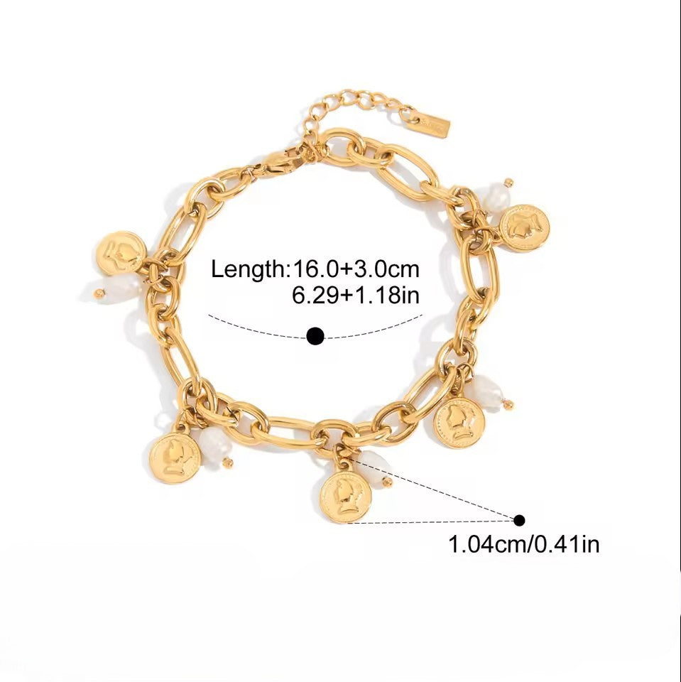 Gold bracelet with charms and measurements on a white background