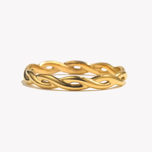 Gold ring with a wavy design on a white background