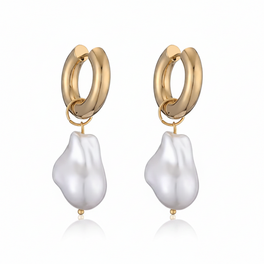 Gold hoop earrings with white baroque pearl drops on a white background