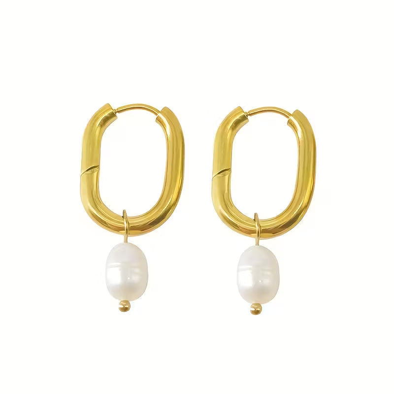 Gold hoop earrings with white pearls on a white background