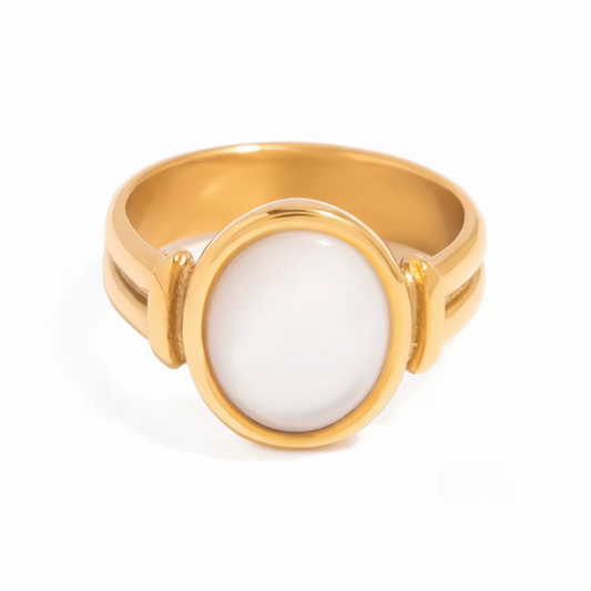 Gold ring with a white stone on a white background