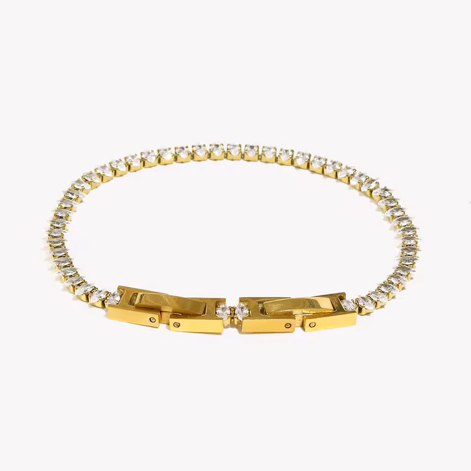 Gold bracelet with diamond accents on a white background