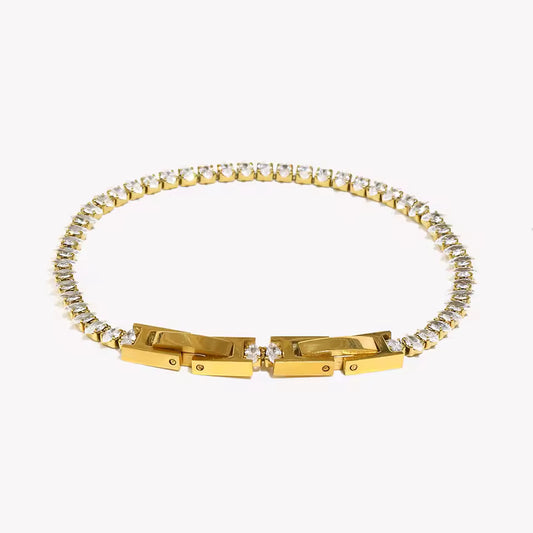 Gold bracelet with diamond accents on a white background