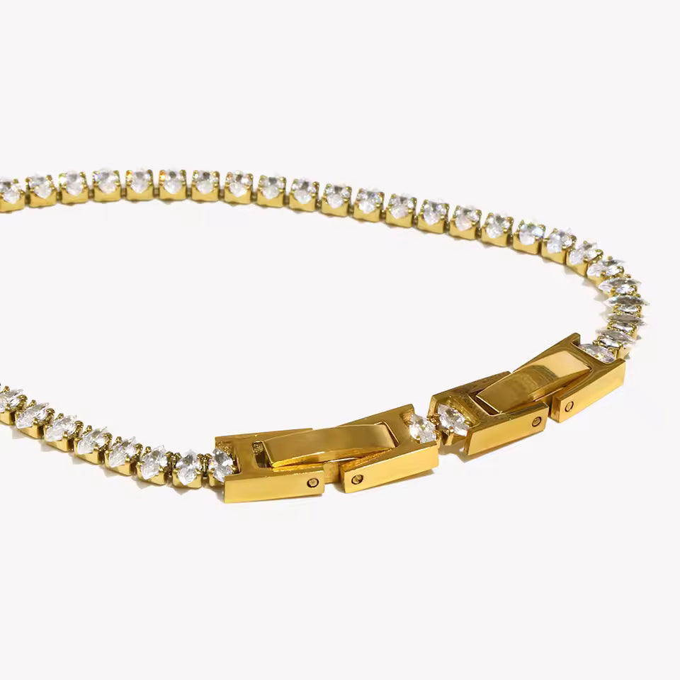 Gold bracelet with diamond accents on a white background