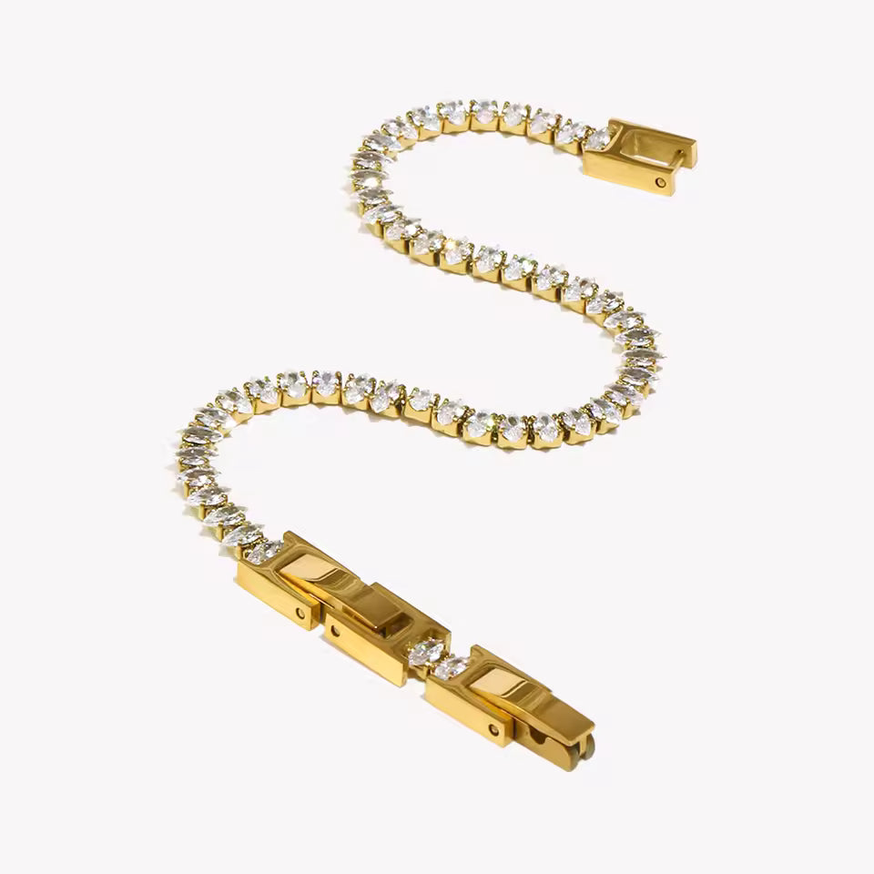 Gold bracelet with diamond accents on a white background