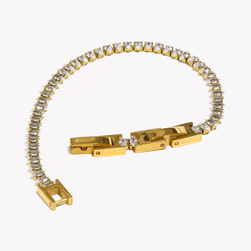 Gold bracelet with diamond accents on a white background