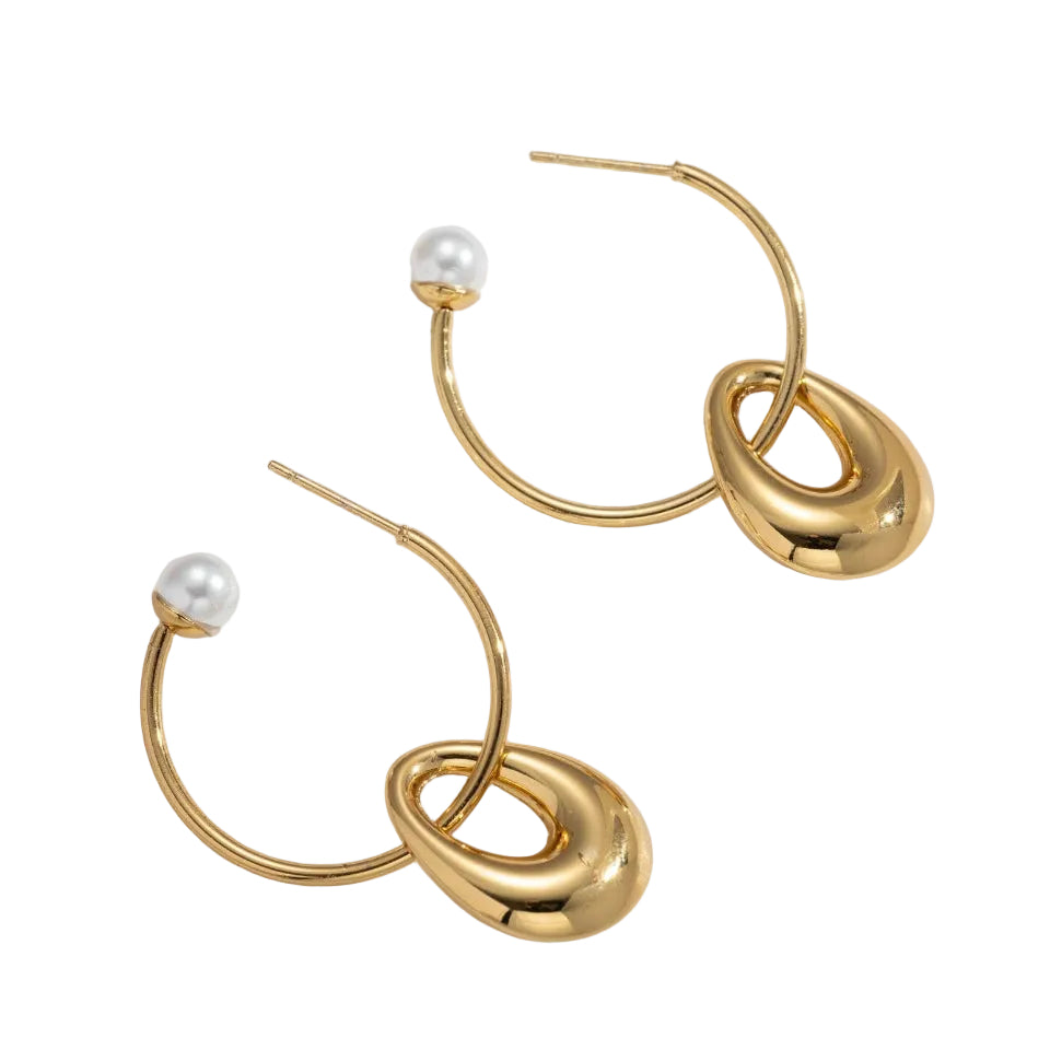 Gold hoop earrings with pearl-like beads on a light background