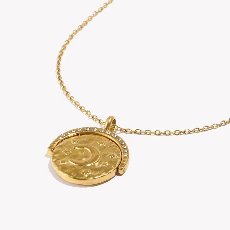 Gold necklace with a round pendant on a white background