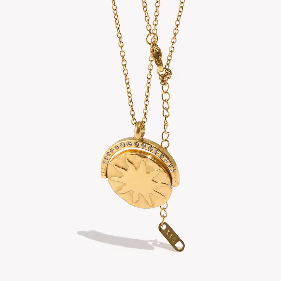 Gold necklace with a pendant on a white background