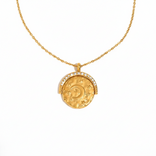 Gold necklace with a moon and star pendant on a white background