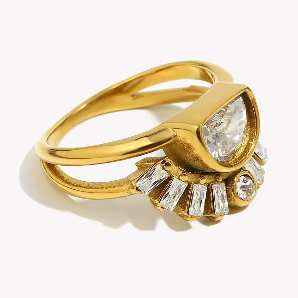 Gold ring with a large diamond and smaller gemstones on a white background