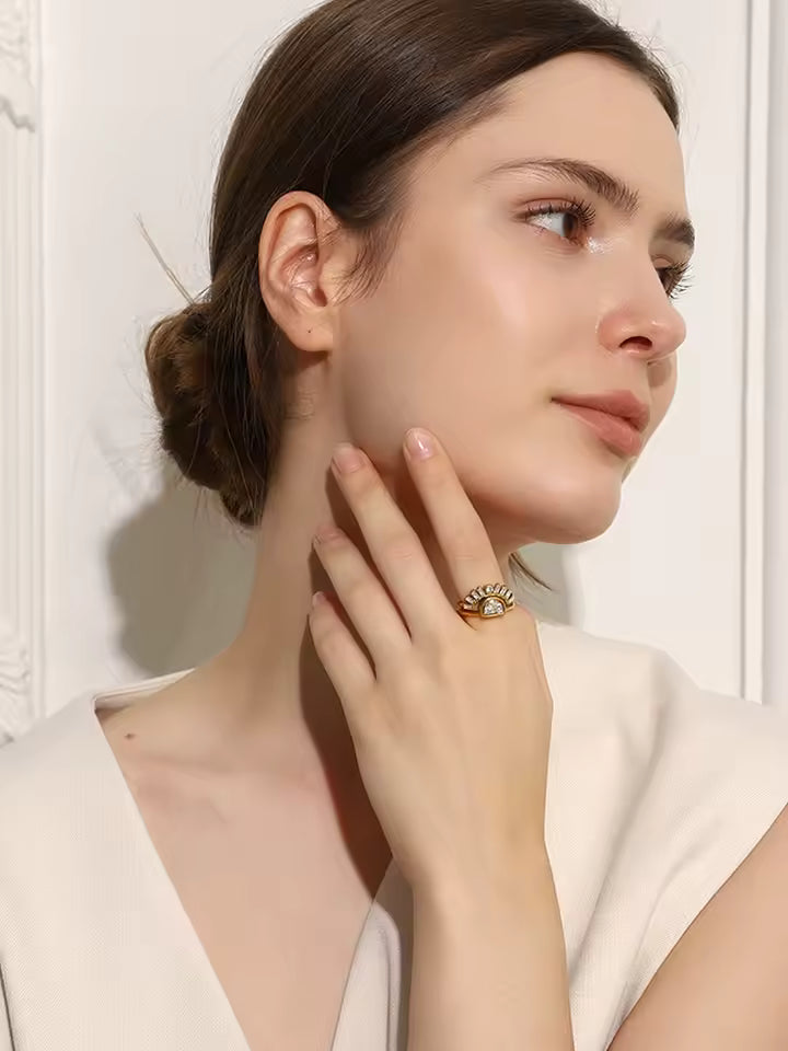Woman wearing a gold ring with a white background
