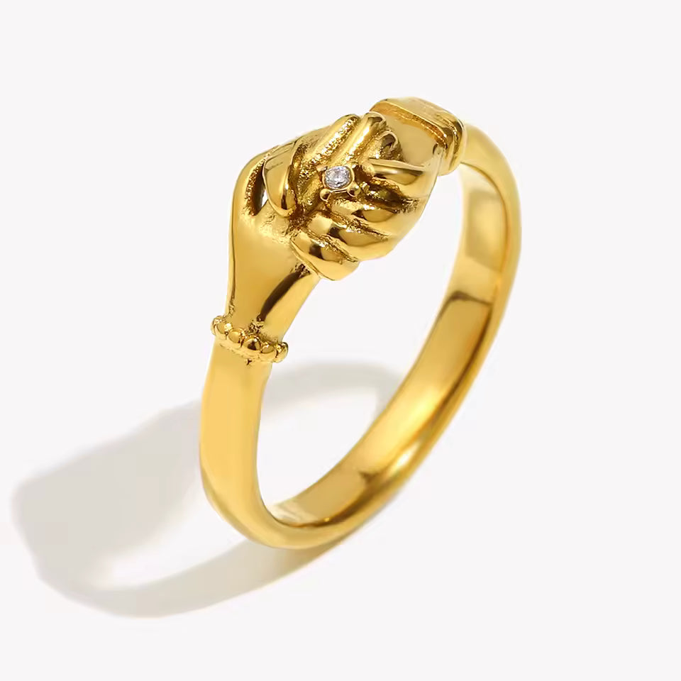 Gold ring with a unique design on a white background