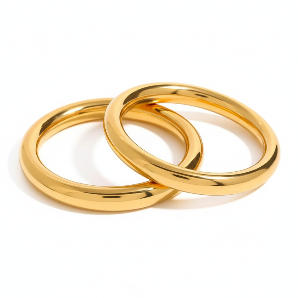 Two gold rings interlocked on a white background