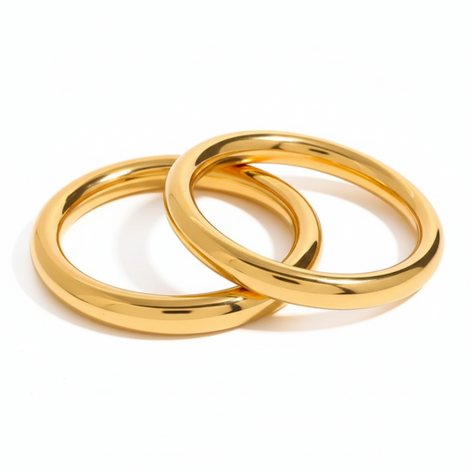Two gold rings interlocked on a white background