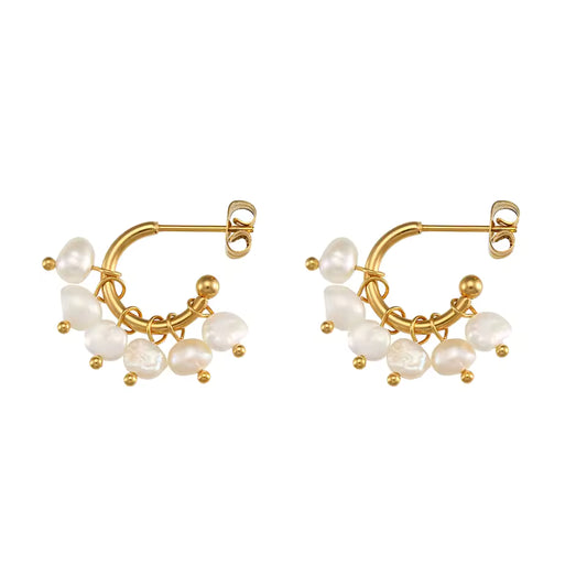 Gold hoop earrings with pearl beads on a white background
