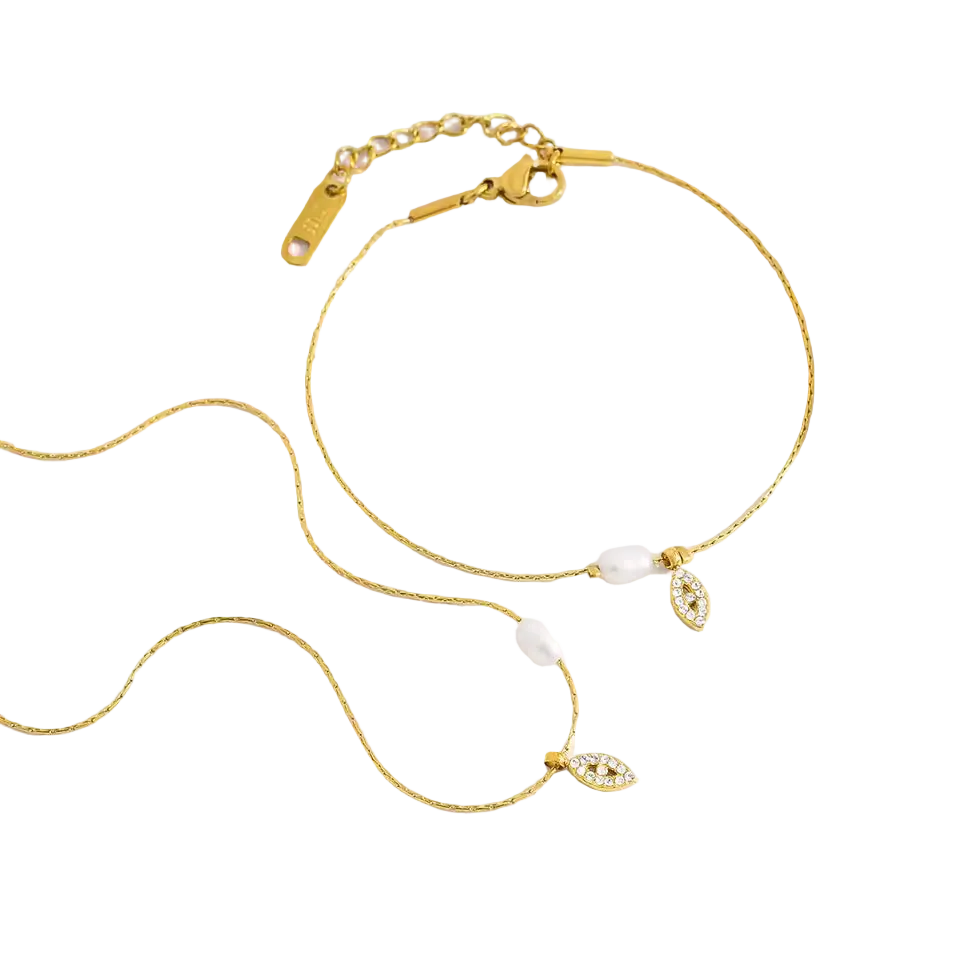 Gold necklace with pearl and gemstone accents on a white background