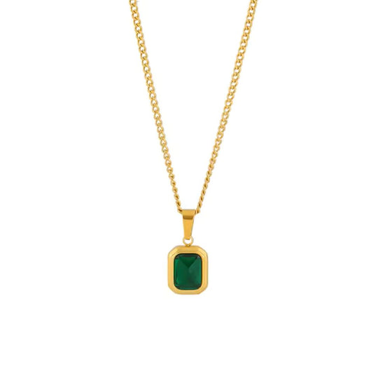 Gold necklace with a green gemstone pendant on a white background