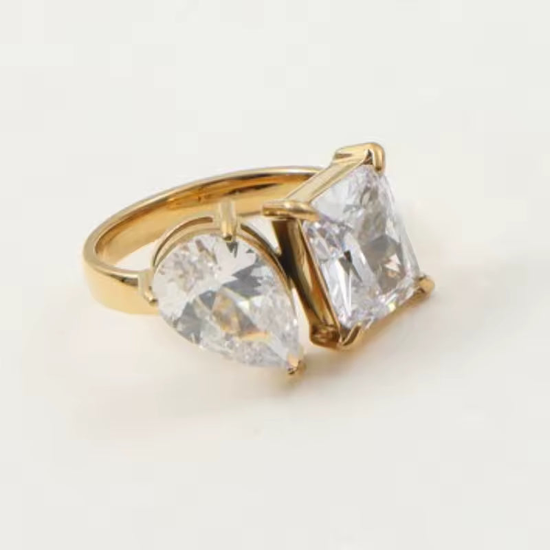 Ring with two cubic zirconia on plain background