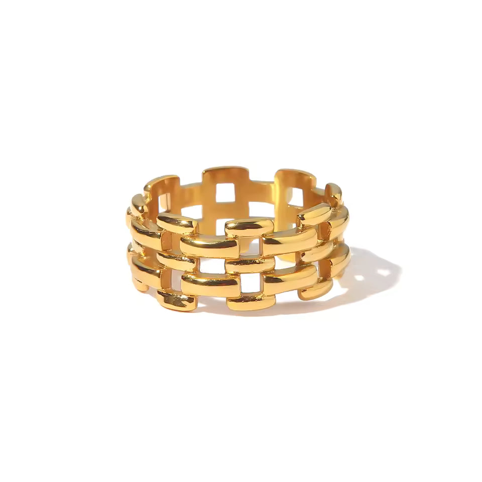Gold chain-style ring on a white background