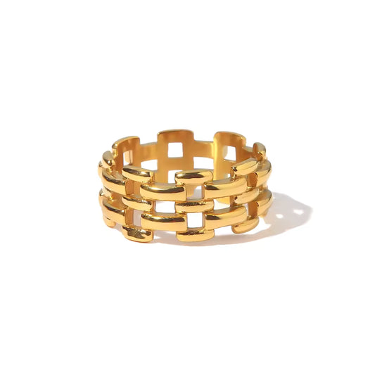Gold chain-style ring on a white background