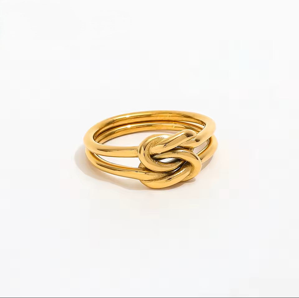 Gold knot ring on a white background