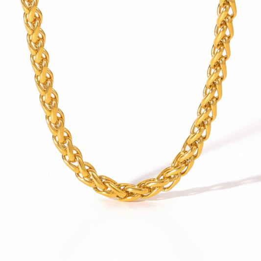 Gold chain necklace on a white background