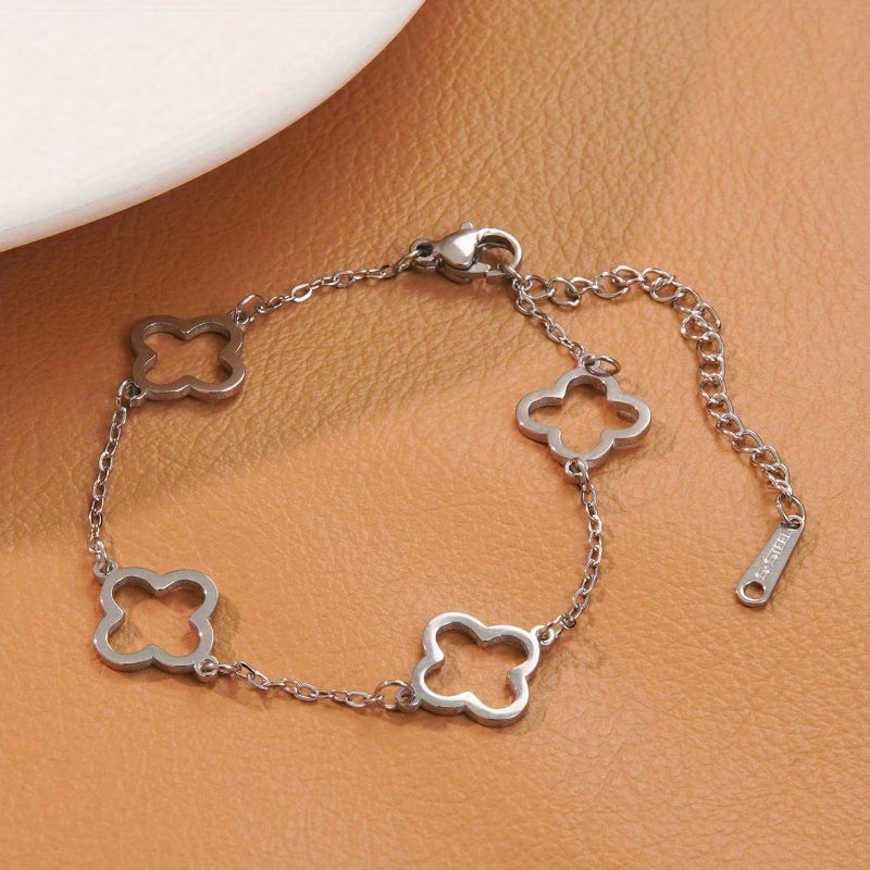 Silver bracelet with clover-shaped links on a brown surface