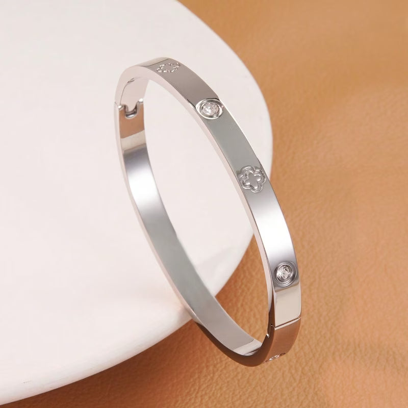 Silver bracelet with diamond-like stones on a beige background
