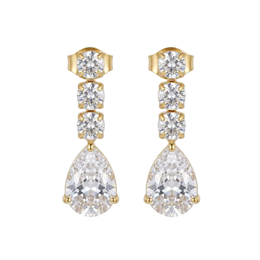 A pair of gold drop earrings featuring a vertical stack of clear teardrop and round crystals, with a larger teardrop crystal hanging at the bottom, displayed on a clean white surface.