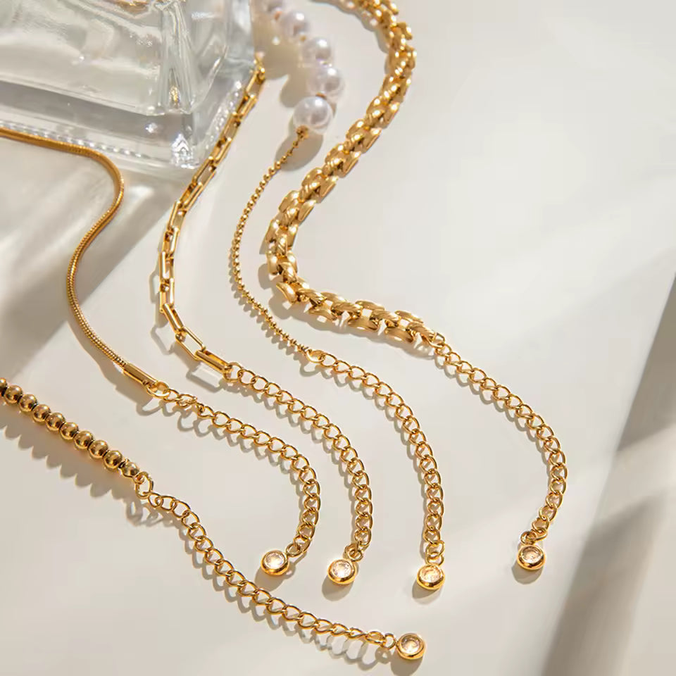 Gold chain necklaces on a light background